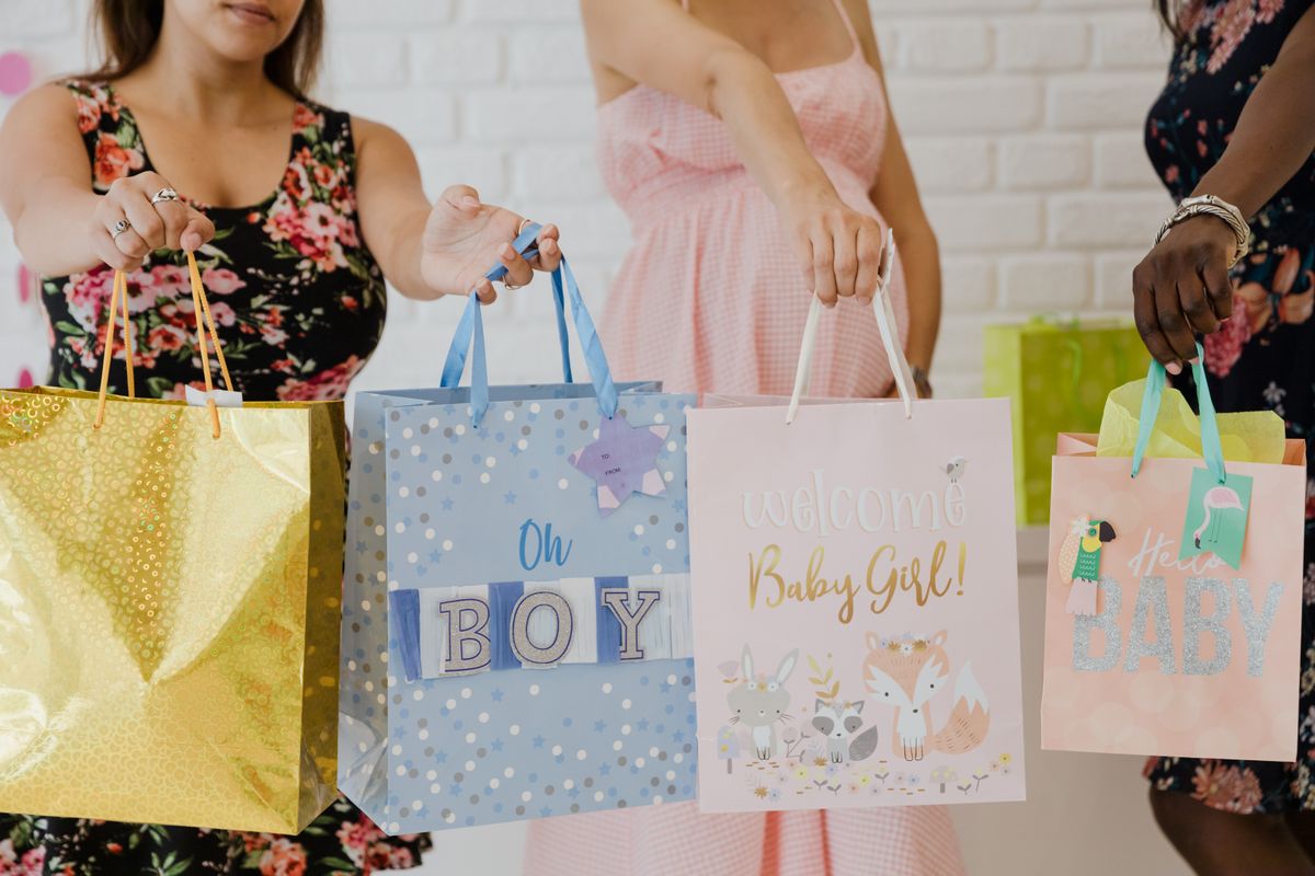 Colourful wrapped gifts and gift bags arranged for a baby shower celebration in the UK