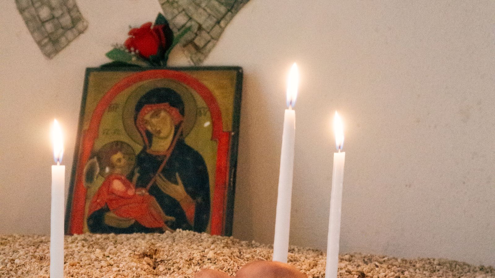 Hands lighting candles in a serene religious ceremony — baptism gifts UK
