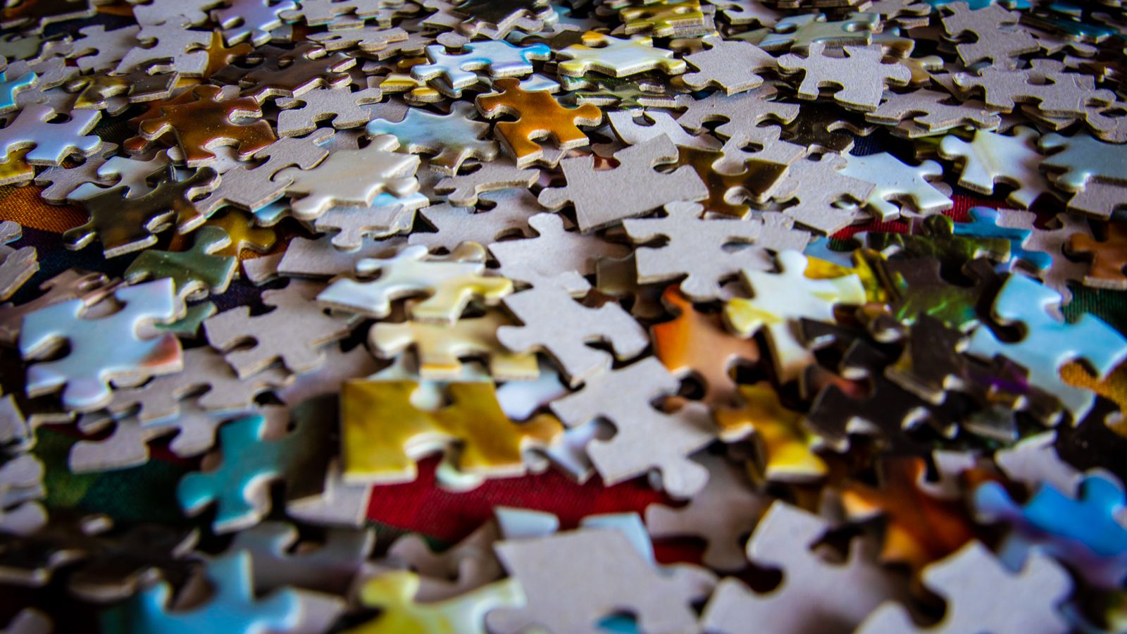 Colourful jigsaw puzzle pieces scattered across a table — birthday gifts for 6 year olds UK