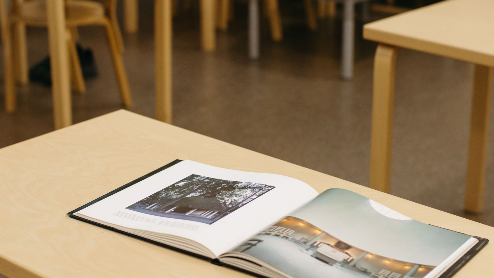 Large open book lying on a pale wooden table, birthday gifts for 8 year olds UK