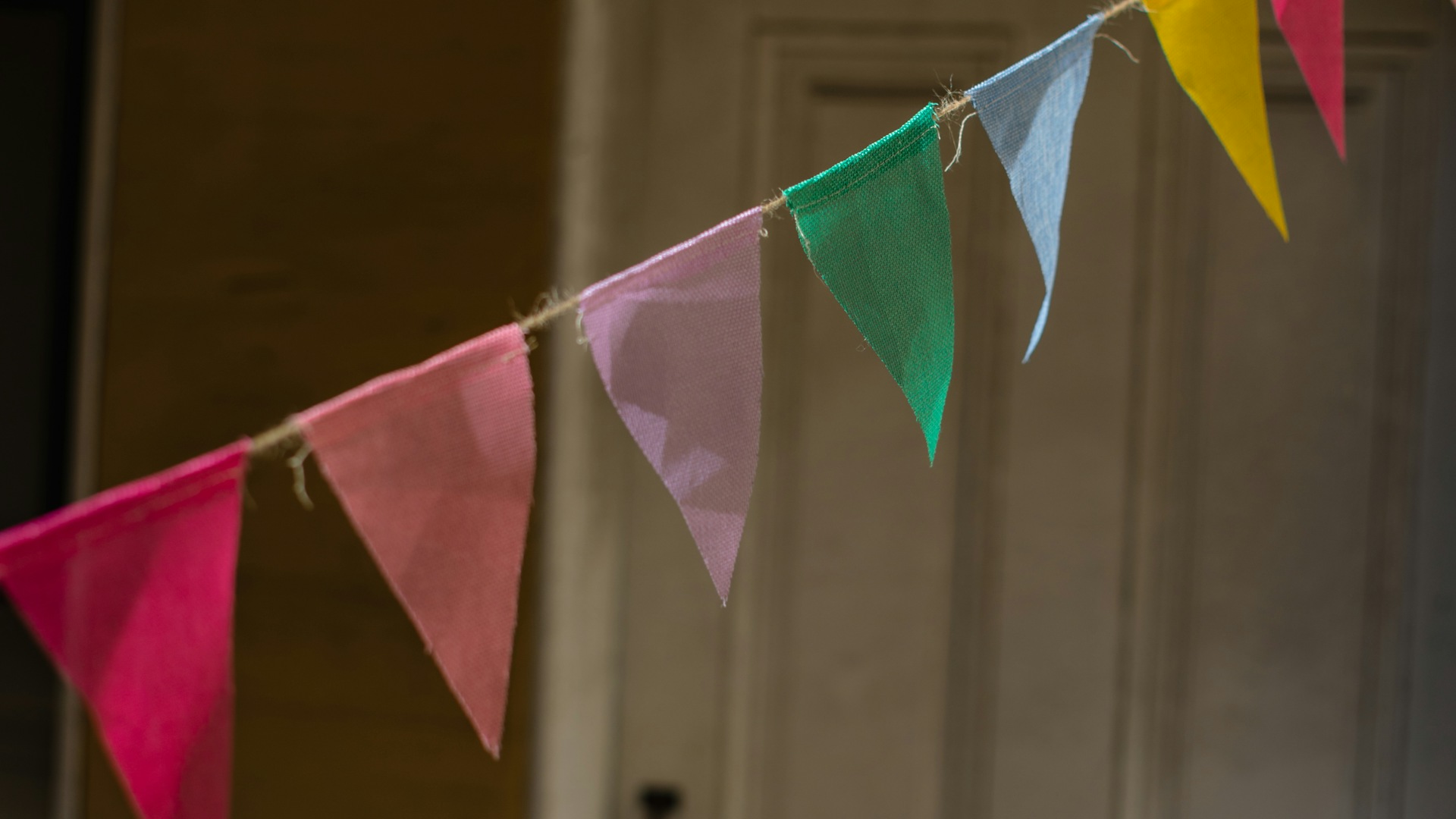 Colourful fabric bunting strung across a doorway &mdash; kids birthday party ideas at home UK