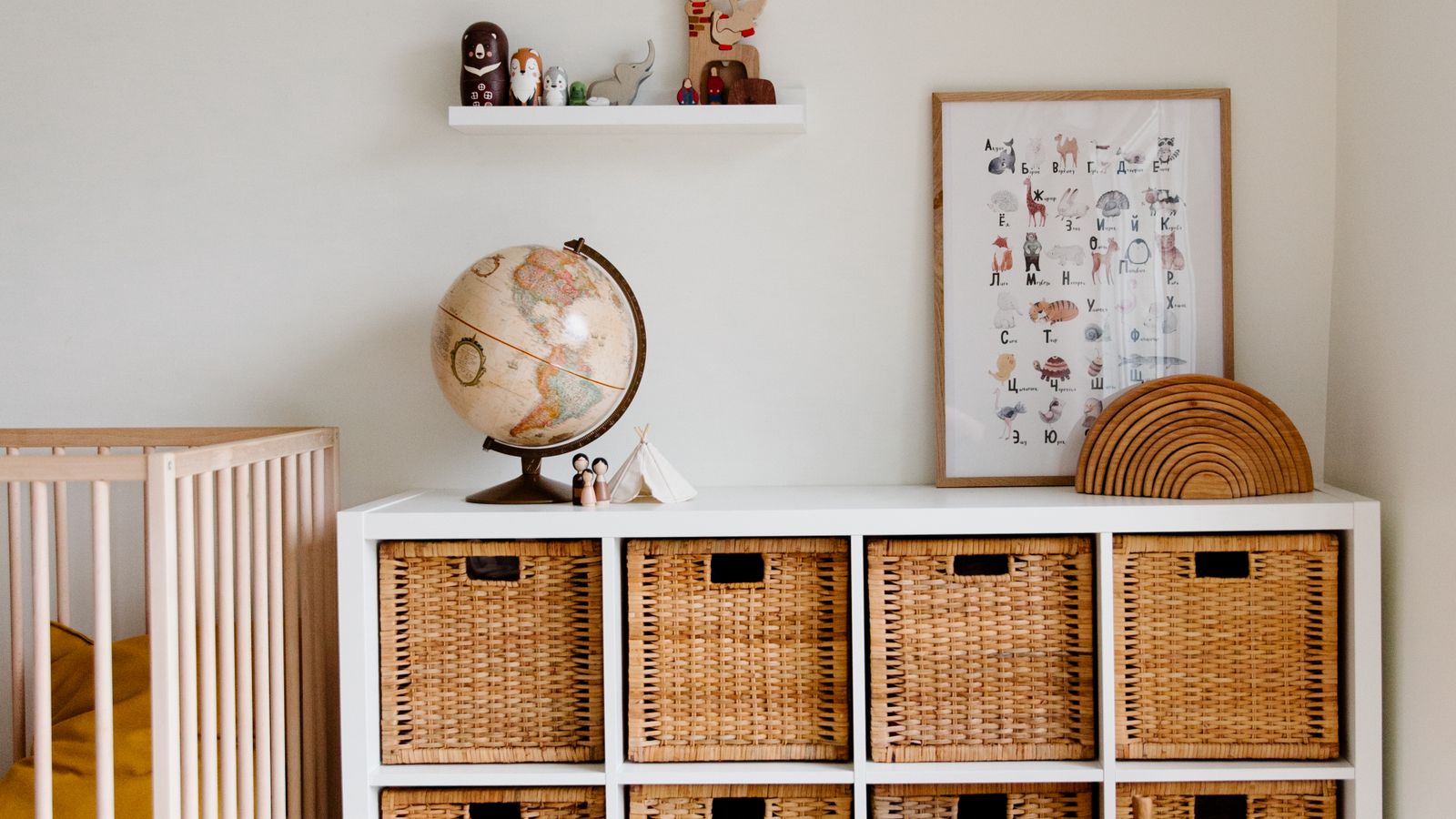 A child&rsquo;s room shelf unit with woven storage baskets, a globe and an alphabet print, what to buy a child who has everything