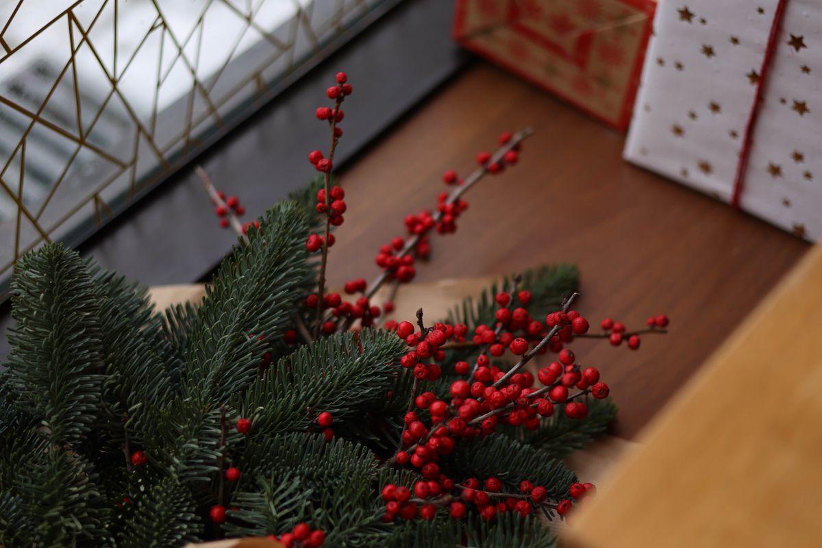 A festive arrangement of wrapped gifts and pine branches for a Christmas Eve box