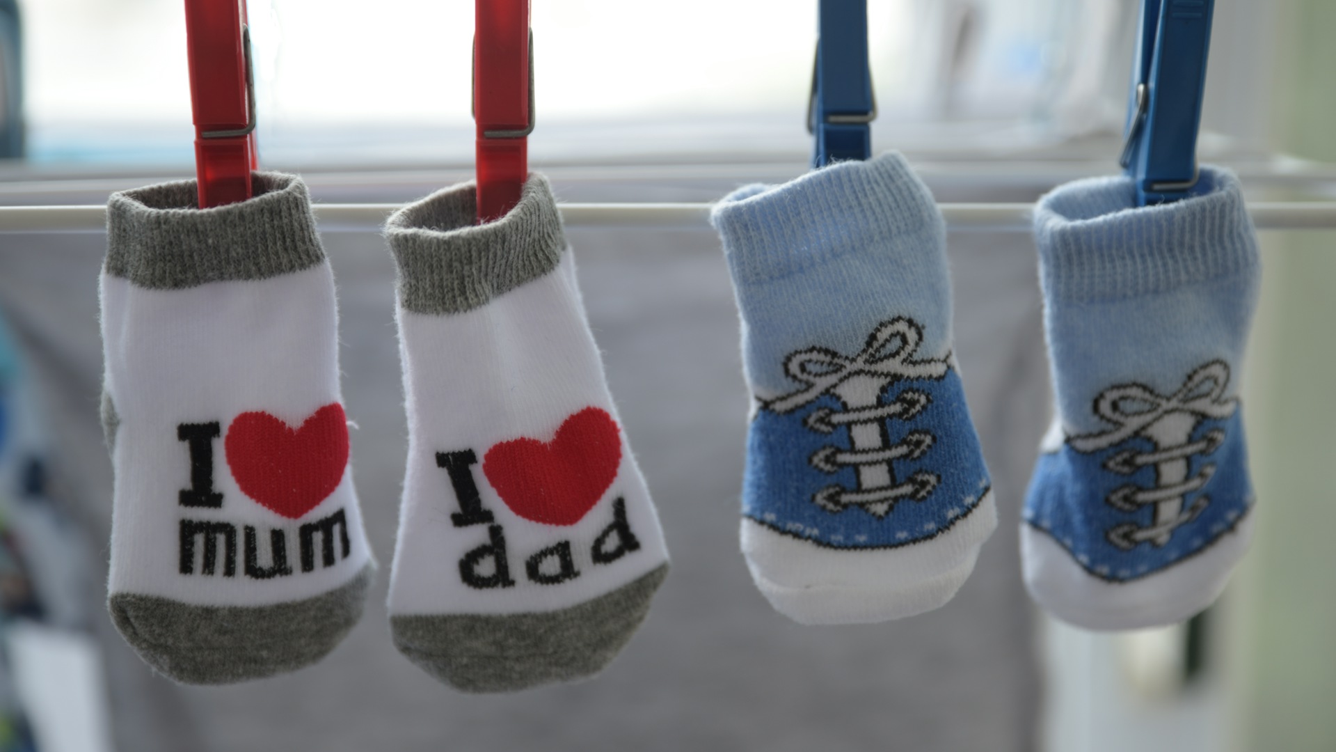 Two pairs of baby socks pegged side by side on a washing line &mdash; gifts for twins UK