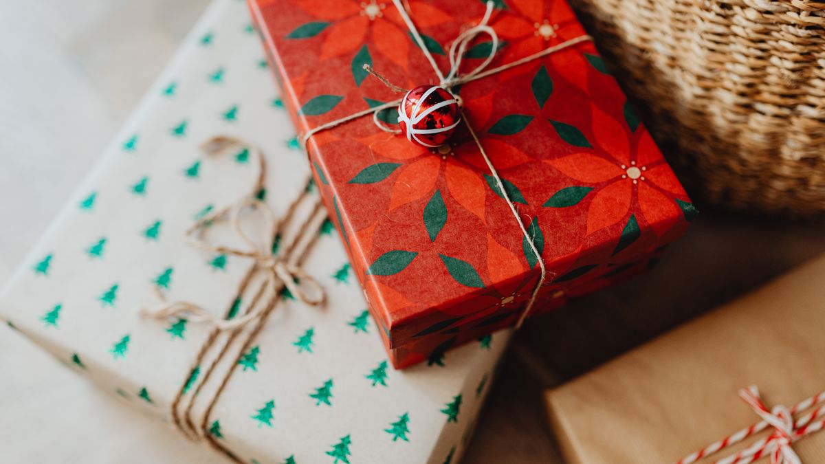 Elegantly wrapped Christmas presents tied with twine and a bauble